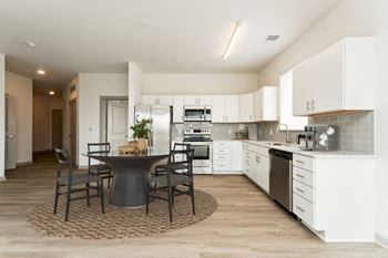a kitchen and dining room with a table and chairs at The Waterford At Rocketts Landing Apartments, PRG Real Estate, Richmond, Virginia